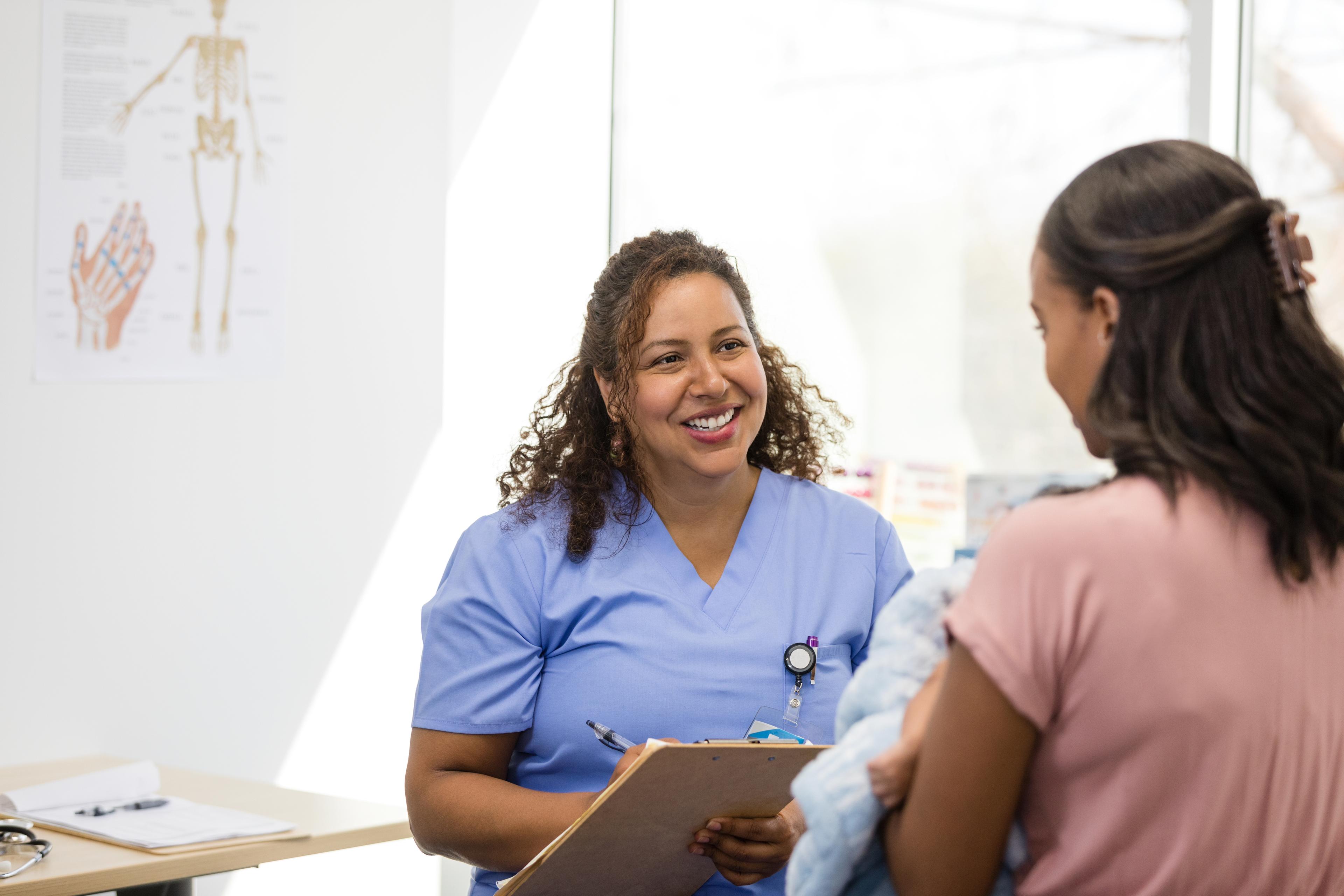 Female doctor smiles while listening to young mother 1480360672.jpg