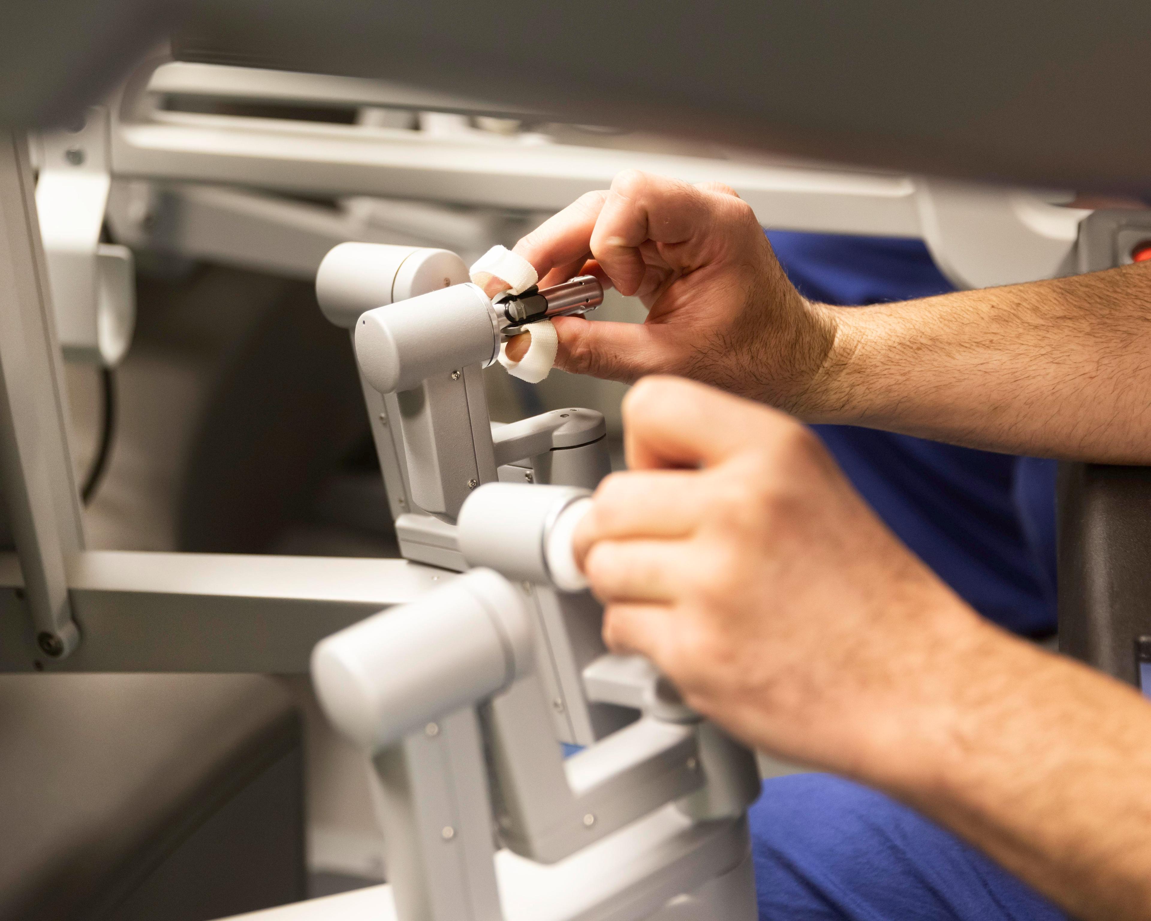 Surgeons hands using robot console